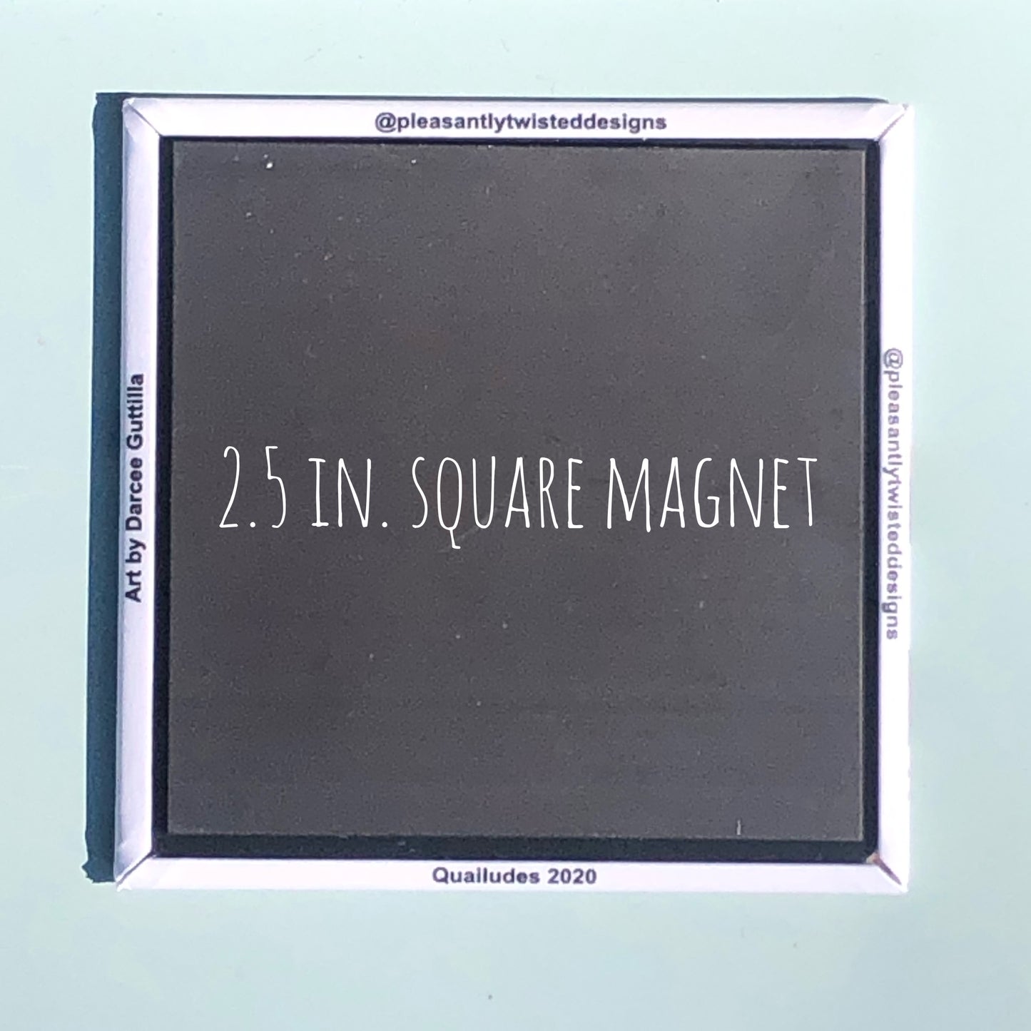 Back side of magnet (black) with text "2.5 in.square magnet", and product information along white margins. Background color light mint.